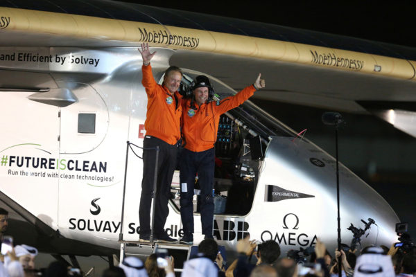 Pilots Andre Borschberg (L) and Bertrand Piccard celebrate after their arrival on Solar Impulse 2, a solar powered plane, at an airport in Abu Dhabi, United Arab Emirates July 26, 2016. REUTERS/Stringer - RTSJMET